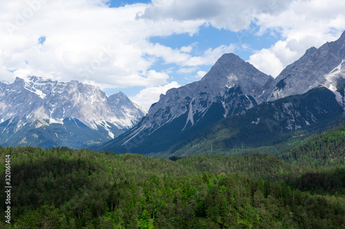 View to the Zugspitze with a forest in the foreground