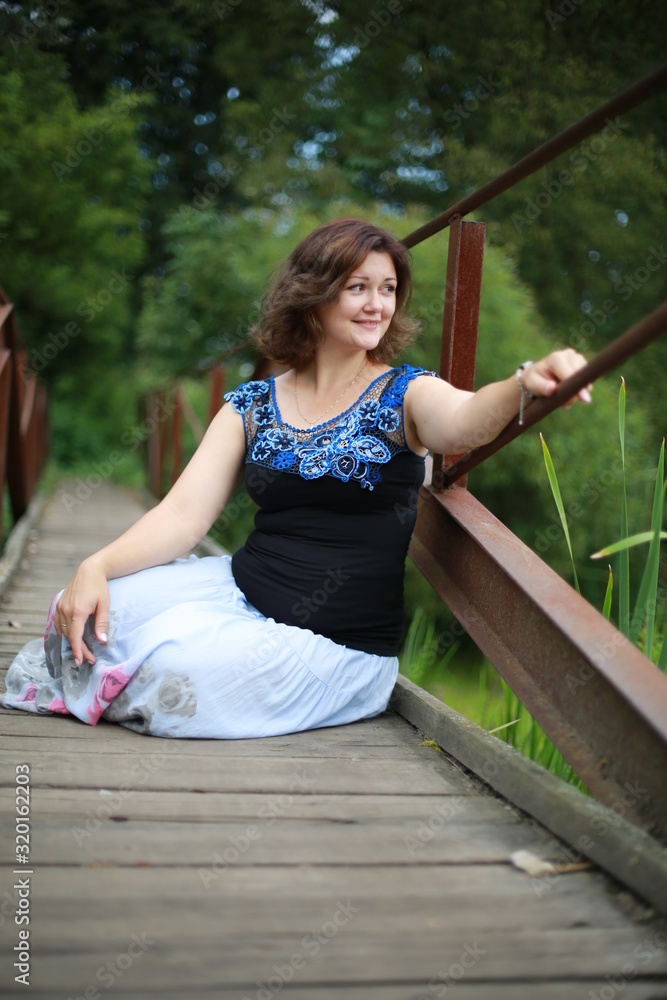  young woman in park in a blouse of Irish lace