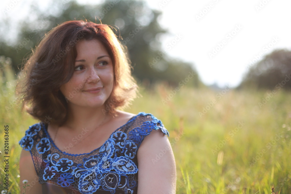 portrait of young woman in park in a blouse of Irish lace