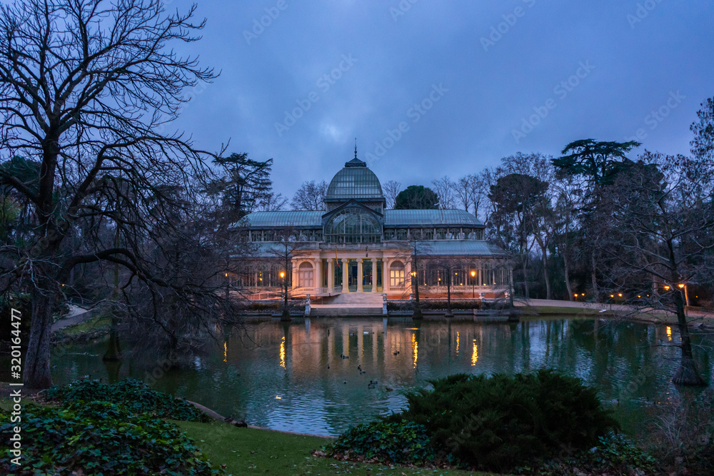 Front view of the Crystal Palace in El Retiro Park in Madrid at dawn, cloudy day, romantic style pavilion, travel concept