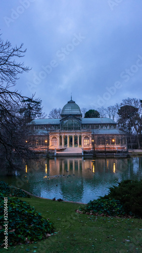 Front view of the lagoon and the Crystal Palace in El Retiro Park in Madrid at dawn, cloudy day, romantic style pavilion, travel concept