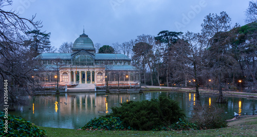 Views of the lagoon and the Crystal Palace in the Retiro Park in Madrid on a cloudy day, travel concept.