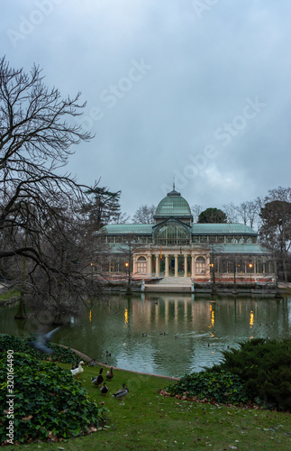 Vertical image of sunrise in the Retiro Park in Madrid, next to the glass palace on a cloudy day, travel concept