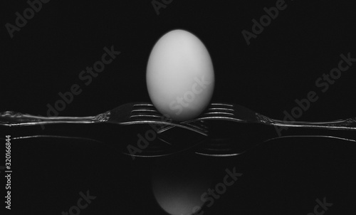 broken egg on black background