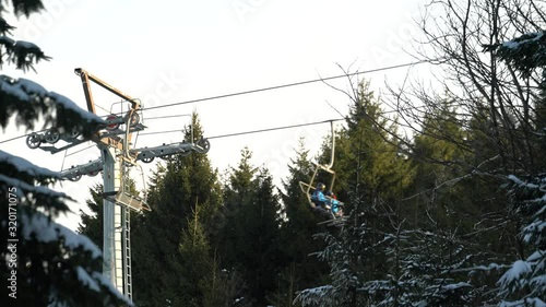 Chairlift with skiers in the mountains