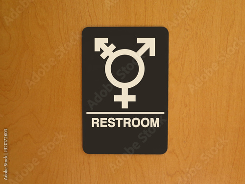Restroom sign with a graphic symbol and the word, 