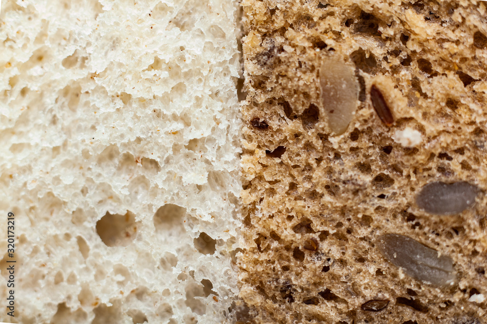 Slice of white bread and whole grain bread side by side Slice of white bread and whole grain bread side by side
