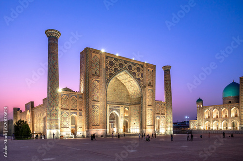 Samarqanda, Uzbekistan - 09 20 2019: The Ulugh Beg Madrasah on historic Registan Square in Samarqand during sunset in summer  photo