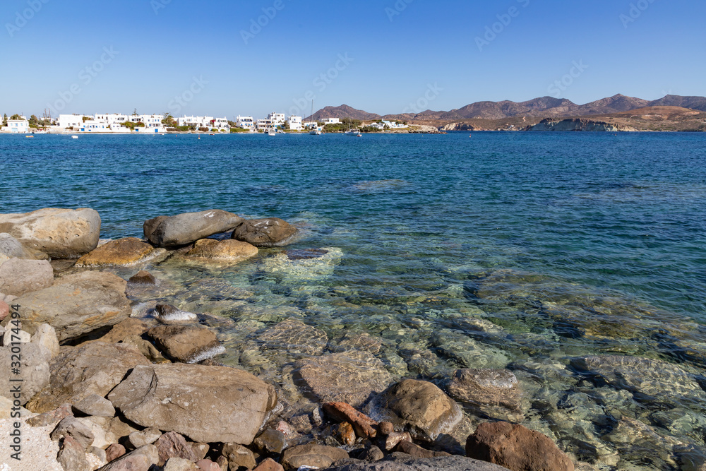 Rocks, mountains and buildings at beach in Pollonia village