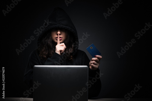 Female hacker hacking security firewall late in office © Elnur