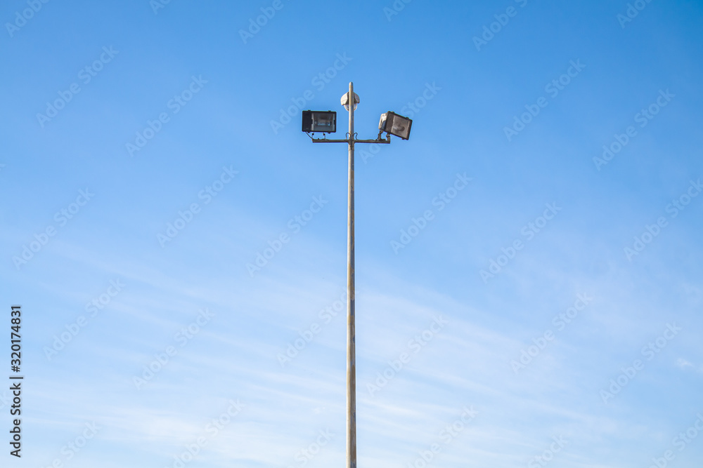 Spotlight at day with blue sky in background Spotlight at day with blue sky in background