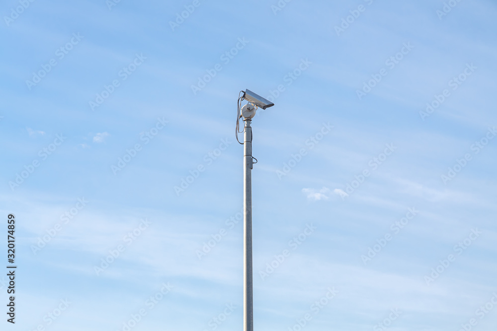 Security camera at day with blue sky in background Security camera at day with blue sky in background