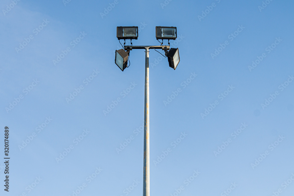 Spotlight at day with blue sky in background Spotlight at day with blue sky in background