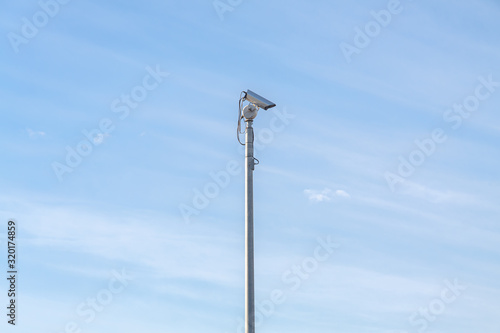 Security camera at day with blue sky in background