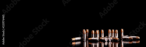 Bullet isolated on black background with reflexion. Rifle bullets close-up on black back. Cartridges for rifle and carbine on a black.