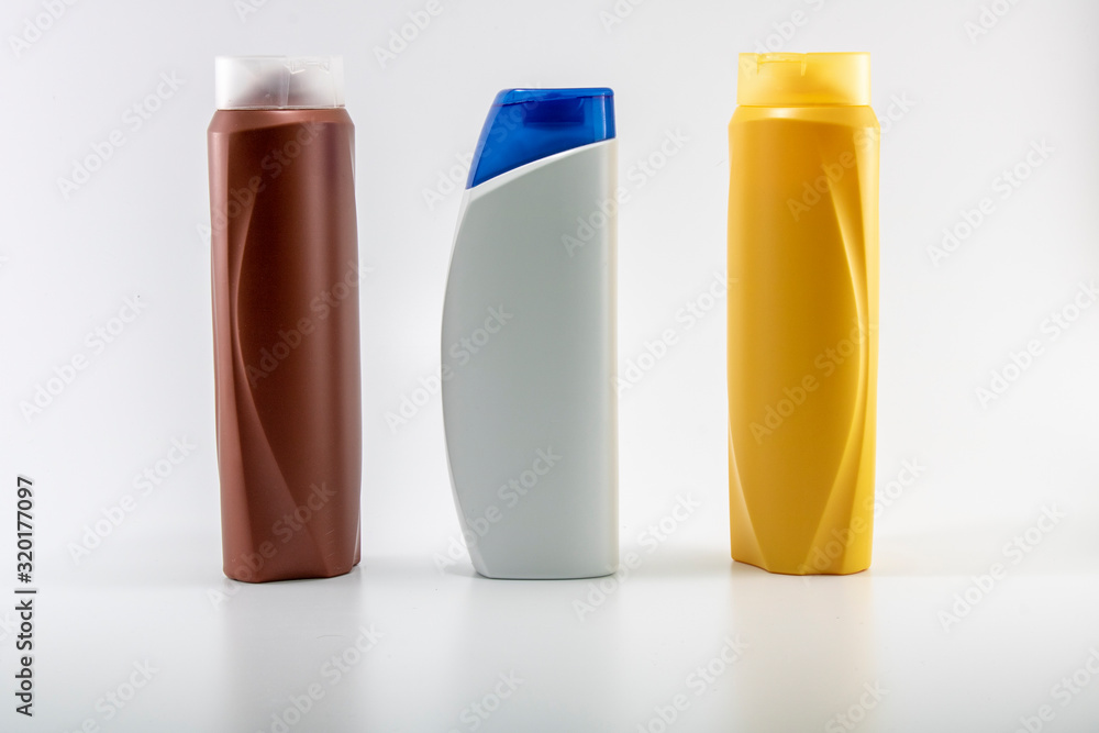 Shampoo bottles photographed on white background. Photographed in a studio setting. Shampoo bottles photographed on white background. Photographed in a studio setting.