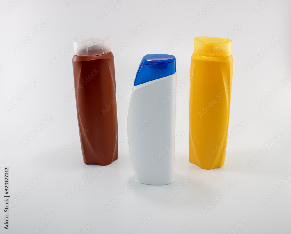 Shampoo bottles photographed on white background. Photographed in a studio setting. Shampoo bottles photographed on white background. Photographed in a studio setting.