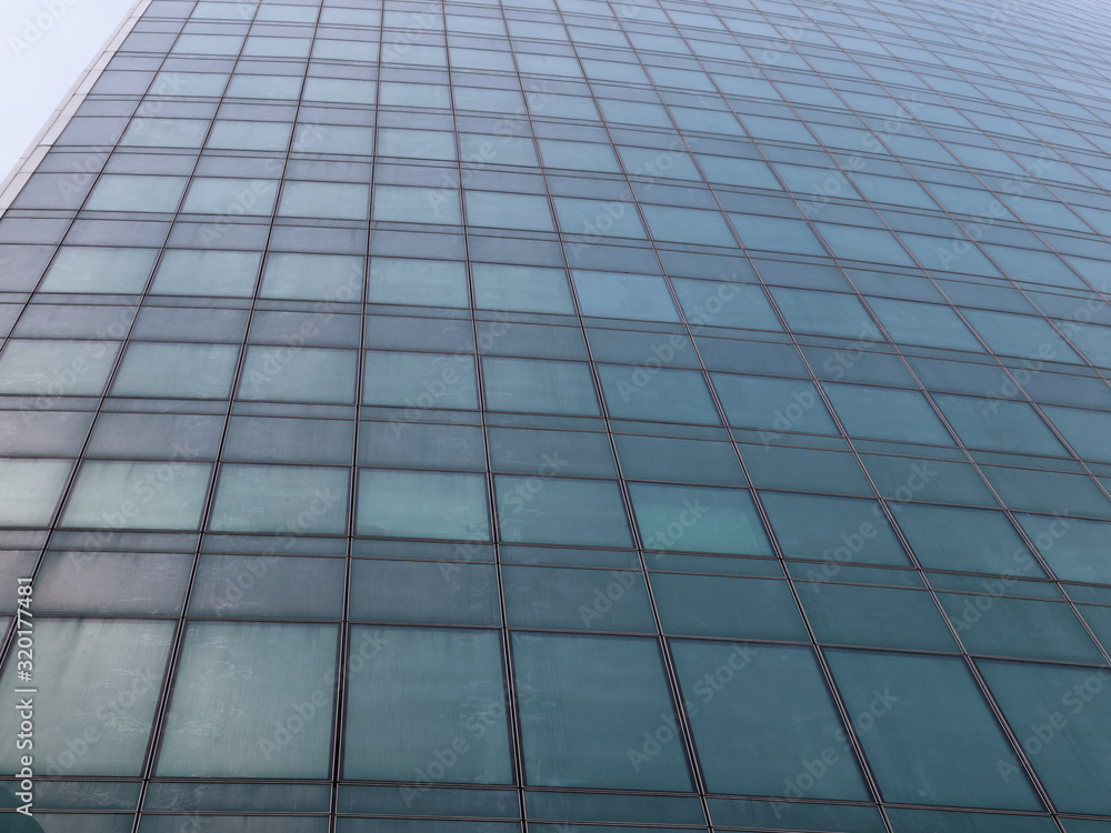 The surface of skyscraper consisting of geometric lines of windows The surface of skyscraper consisting of geometric lines of windows