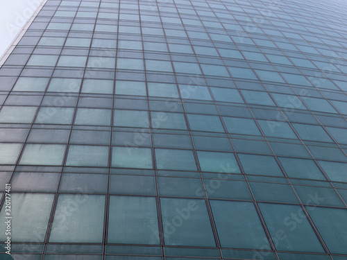 The surface of skyscraper consisting of geometric lines of windows 