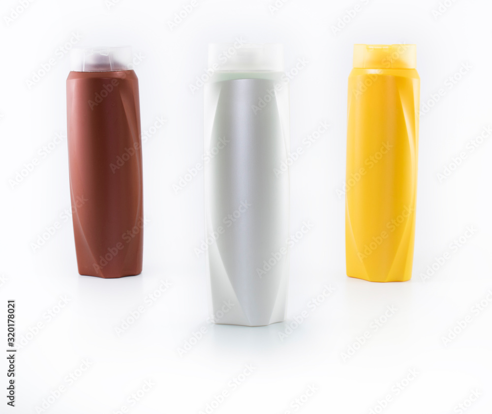 Shampoo bottles photographed on white background. Photographed in a studio setting. Shampoo bottles photographed on white background. Photographed in a studio setting.