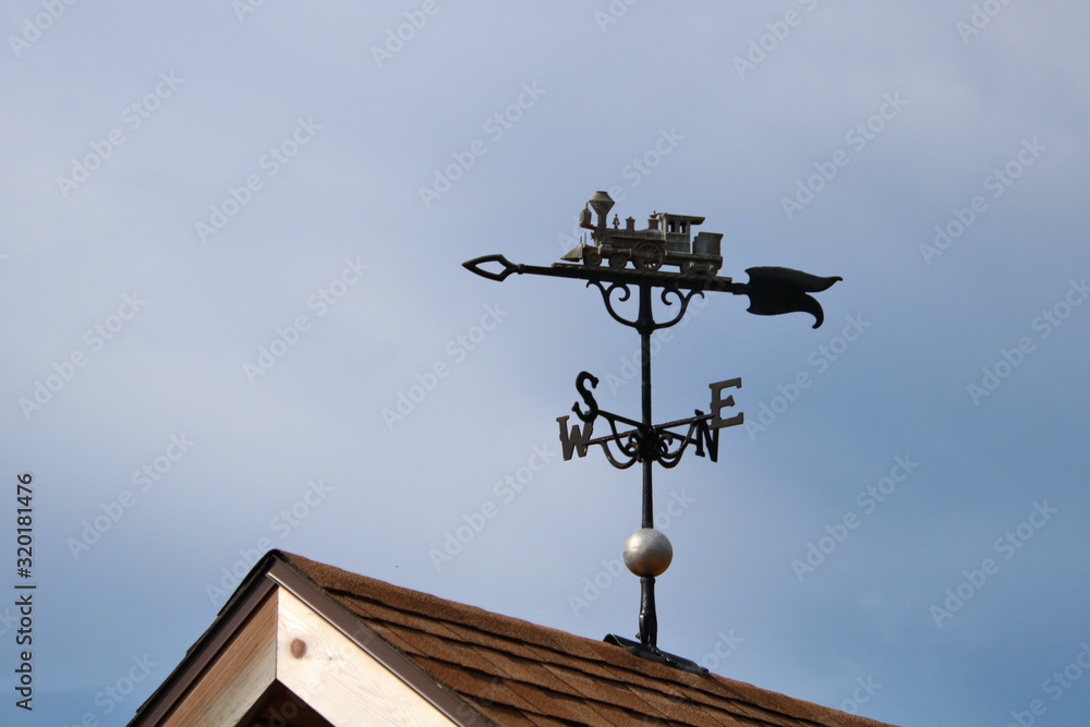 Train topped weather vane on a roof Train topped weather vane on a roof