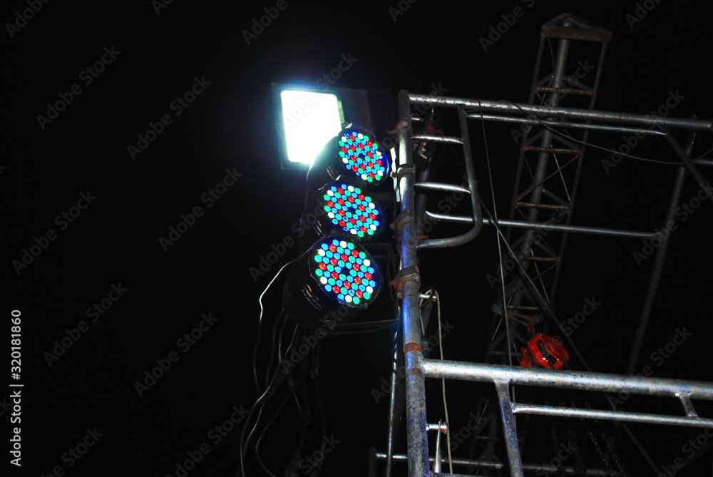 stage lights on the frame mast lighting LED, LED lights bright for the disco and various displays on the stage on a dark black background. Selective focus