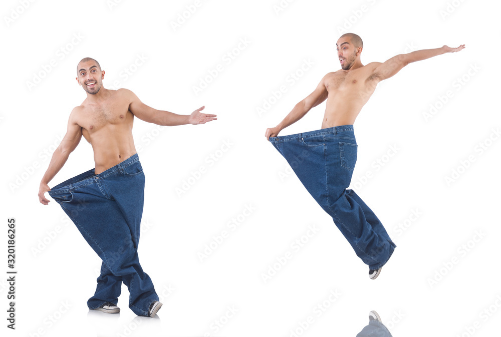 Man in dieting concept with oversized jeans Man in dieting concept with oversized jeans