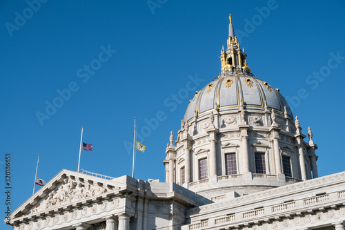 San Francisco City Hall, seat of the government for the City and County of San Francisco, California, flying flags at half mast as a sign of respect after the passing of an important political figure photo