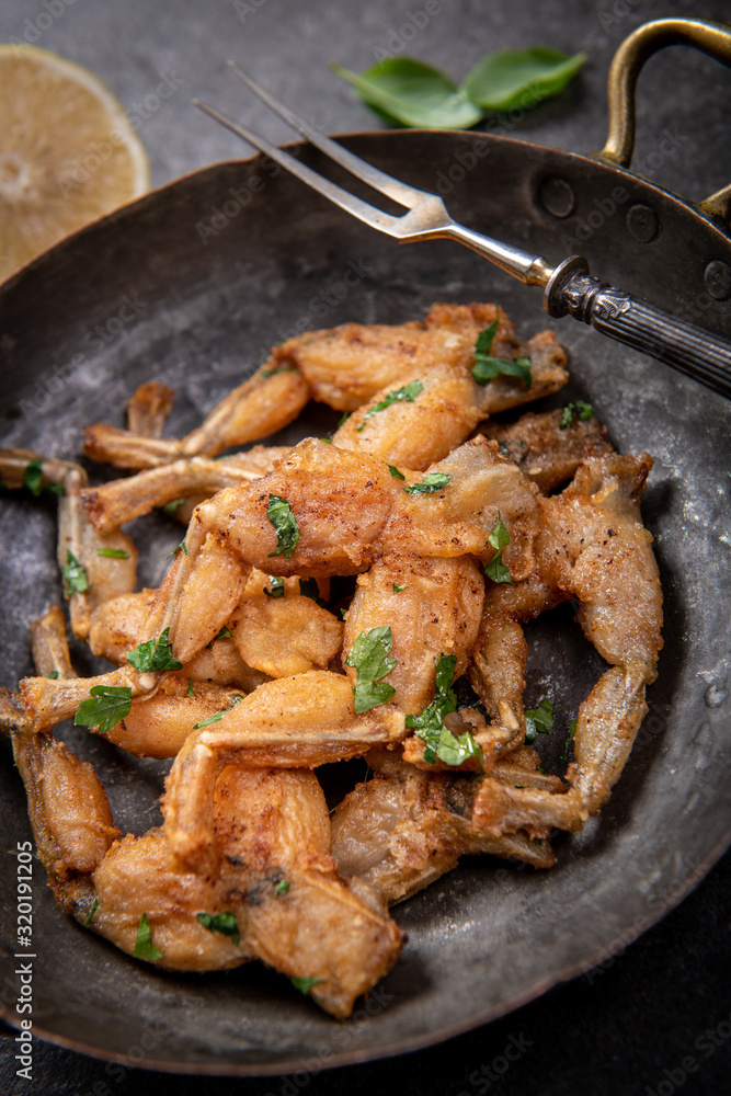 Baked frog legs in french style Baked frog legs in french style