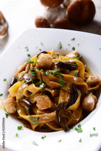 Tagiatelle pasta with creamy sauce with porcini mushrooms