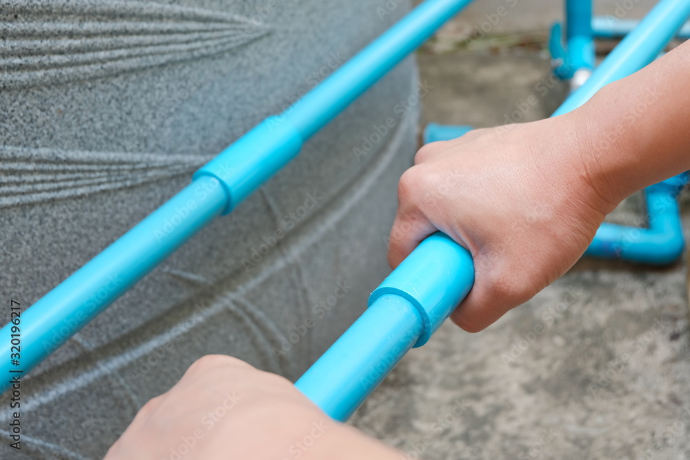 PVC pipe connecting. Hand with tube. Hand holding tube for joint connection.