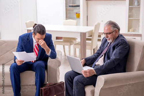 Two businessman discussing business in office