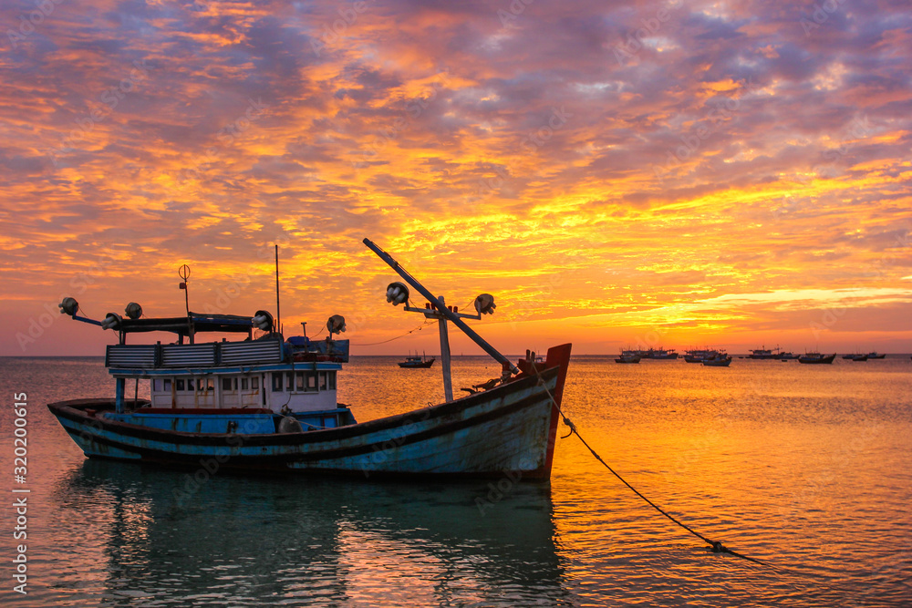 Fishing boats against the background of a purple sunset