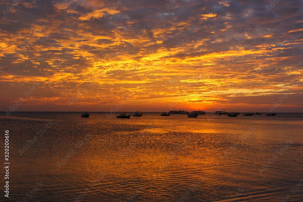 Fishing boats on the background of a golden sunset