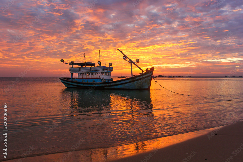 Fototapeta premium Fishing boats against the background of a purple sunset