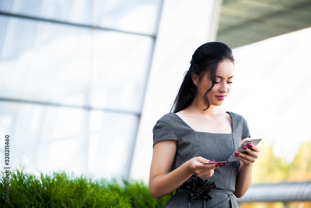 She is Using Gold Credit card and Cellphone For Paying She is Using Gold Credit card and Cellphone For Paying