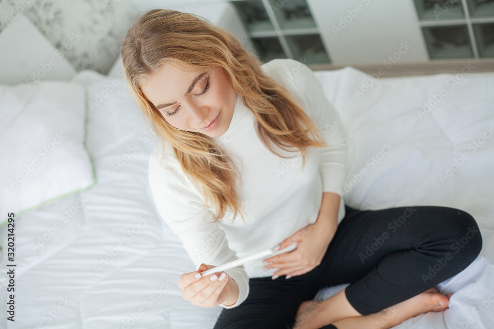 Happy woman Looking at a Pregnancy Test after result. Happy woman Looking at a Pregnancy Test after result.