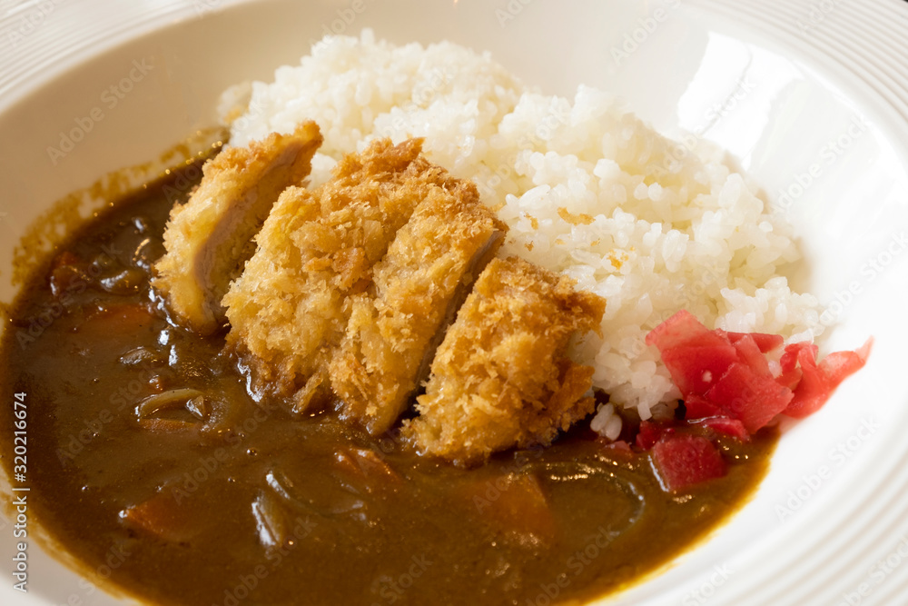 Japanese Curry Rice Deep-fried pork cutlets on a white plate Japanese Curry Rice Deep-fried pork cutlets on a white plate