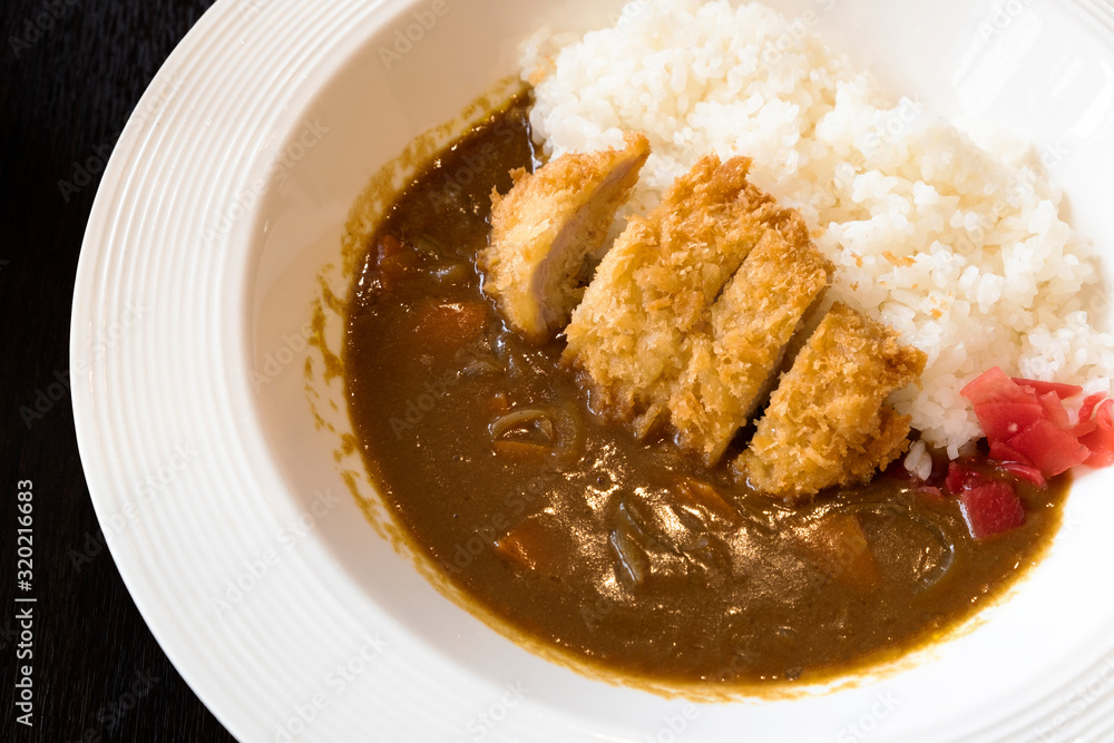 Japanese Curry Rice Deep-fried pork cutlets on a white plate Japanese Curry Rice Deep-fried pork cutlets on a white plate