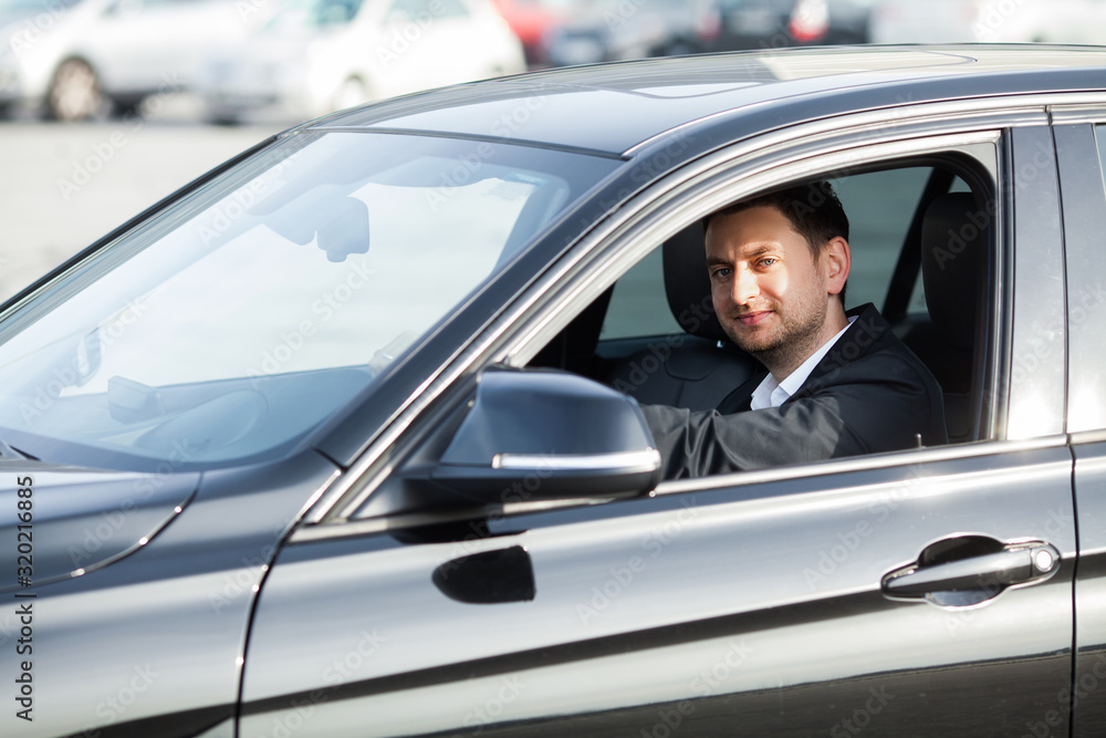 Young happy man bought new modern car.