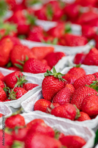 Fresh strawberries in the baskets for sale at farmers market