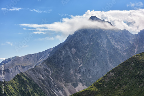 White clouds caught on to peak