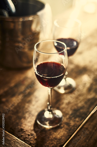 Red wine on wood background..