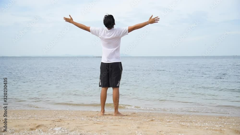 Relax asian man barefoot walking on tropical summer beach feeling fresh and freedom on holiday. Enjoyment barefoot walk outdoor with freedom. Relaxation Travel Concept. Relax asian man barefoot walking on tropical summer beach feeling fresh and freedom on holiday. Enjoyment barefoot walk outdoor with freedom. Relaxation Travel Concept.