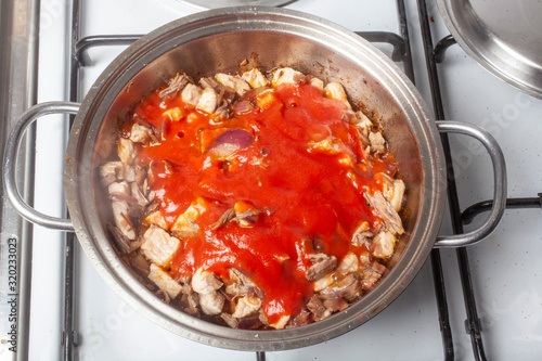 goulasch with tomato in pan