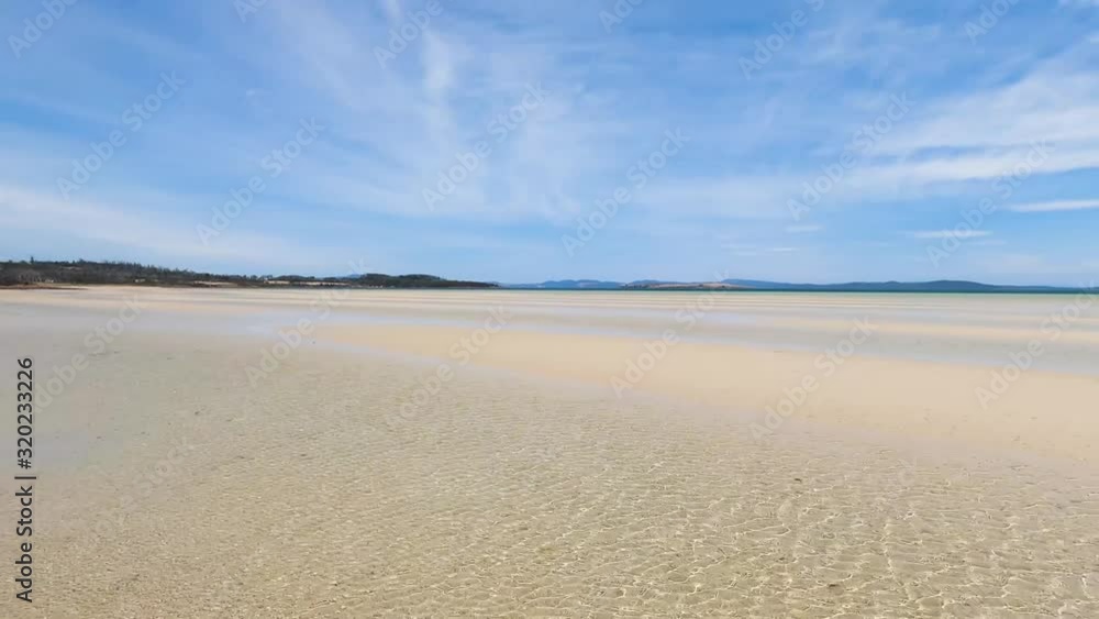 view of Dunalley Beach in Tasmania, Australia with sandbanks and shallow pristine water view of Dunalley Beach in Tasmania, Australia with sandbanks and shallow pristine water