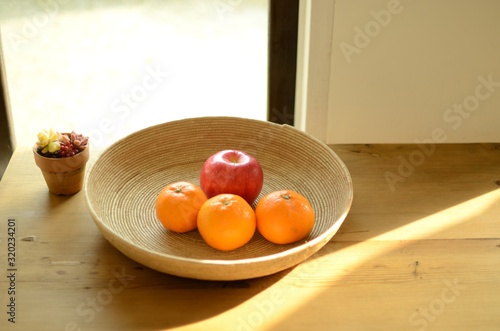 oranges and apple in basket
