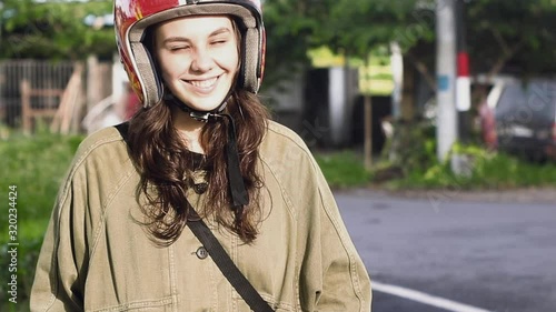 Woman in helmet smiles in the sun