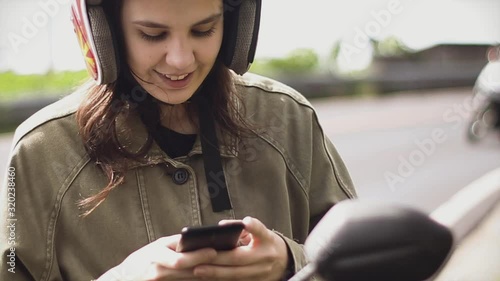 Girl traveler text a message on the phone stopping on a bike at the edge of the road