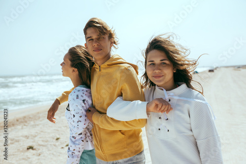 Group of happy teenage friends on the beach